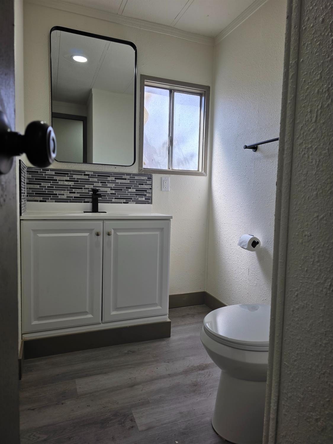 5200 Crest Road Atwater, CA 95301 - Photo 12 of 19 a bathroom with a toilet a sink and mirror