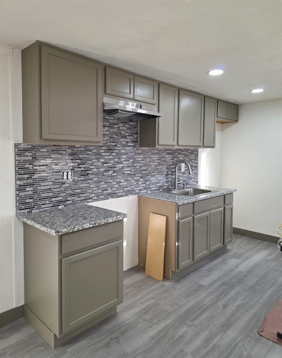 5200 Crest Road Atwater, CA 95301 - Photo 2 of 9 a kitchen with stainless steel appliances granite countertop a sink stove and cabinets