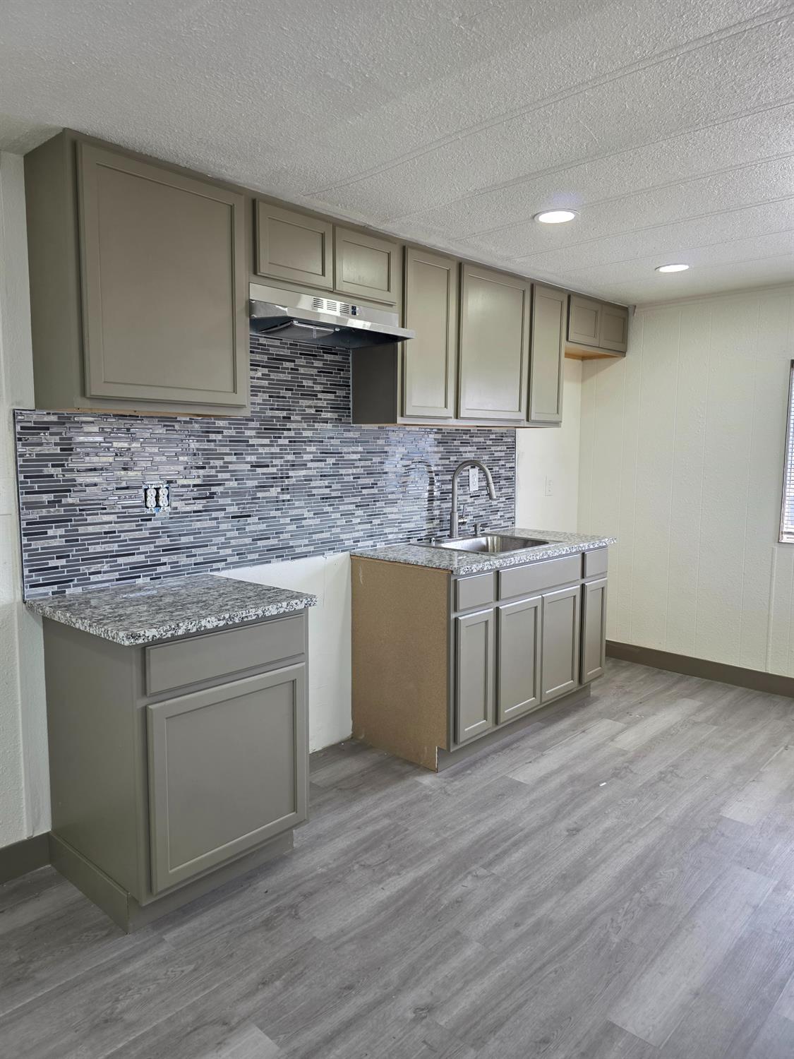 5200 Crest Road Atwater, CA 95301 - Photo 5 of 19 a kitchen with stainless steel appliances granite countertop a sink stove and cabinets