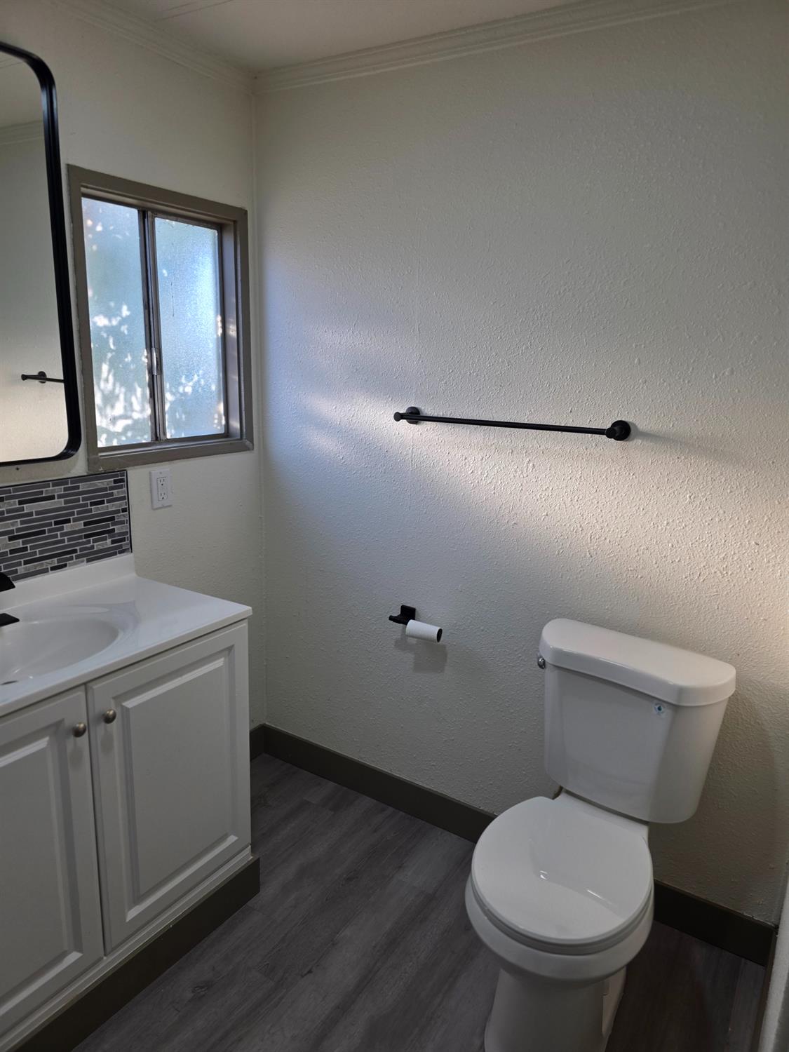 5200 Crest Road Atwater, CA 95301 - Photo 6 of 9 a bathroom with a toilet a sink and mirror