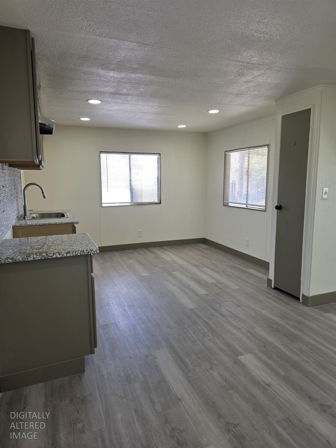 5200 Crest Road Atwater, CA 95301 - Photo 8 of 19 a view of an empty room with a window and wooden floor