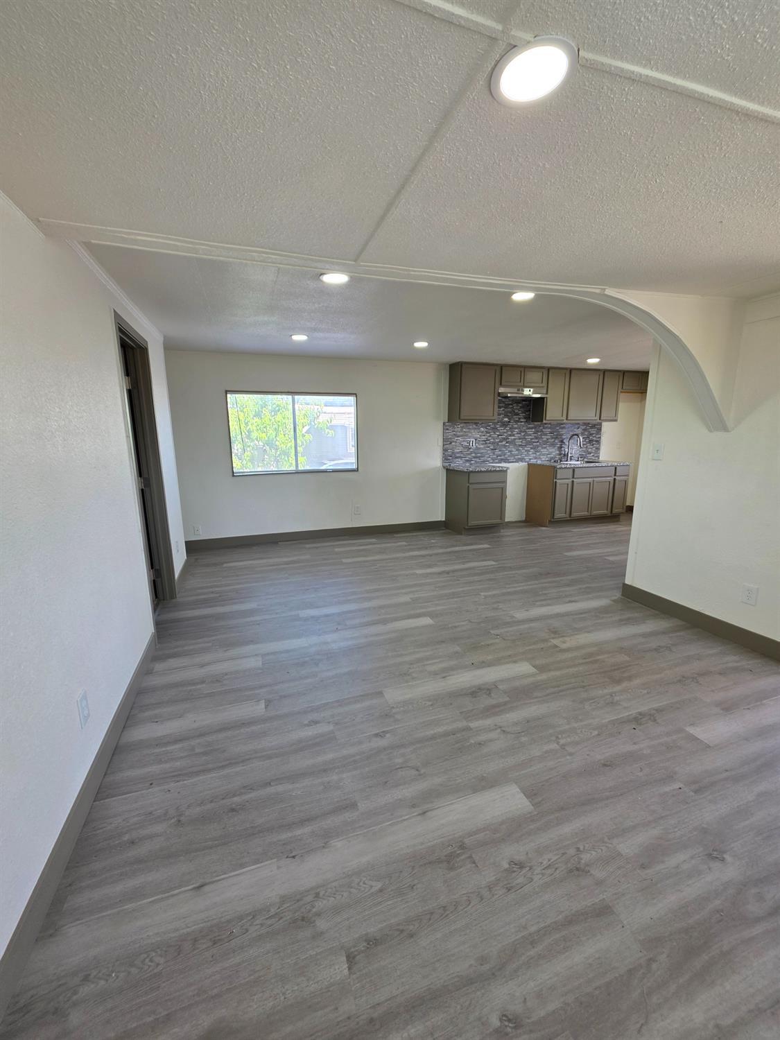 5200 Crest Road Atwater, CA 95301 - Photo 9 of 19 an empty room with wooden floor and windows