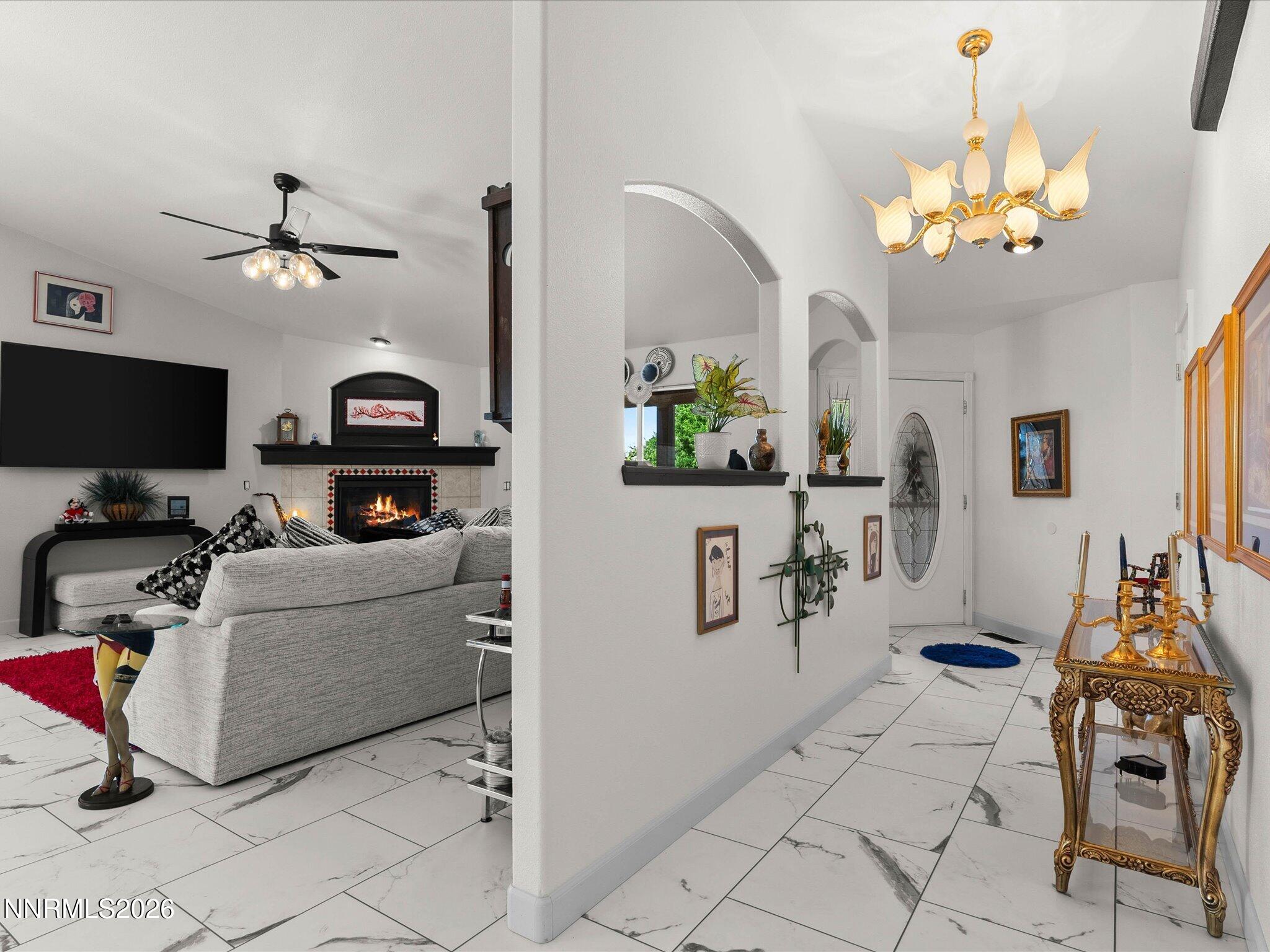 1080 Red Rock Road Fernley, NV 89408 - Photo 7 of 45 a living room with furniture a chandelier and a flat screen tv