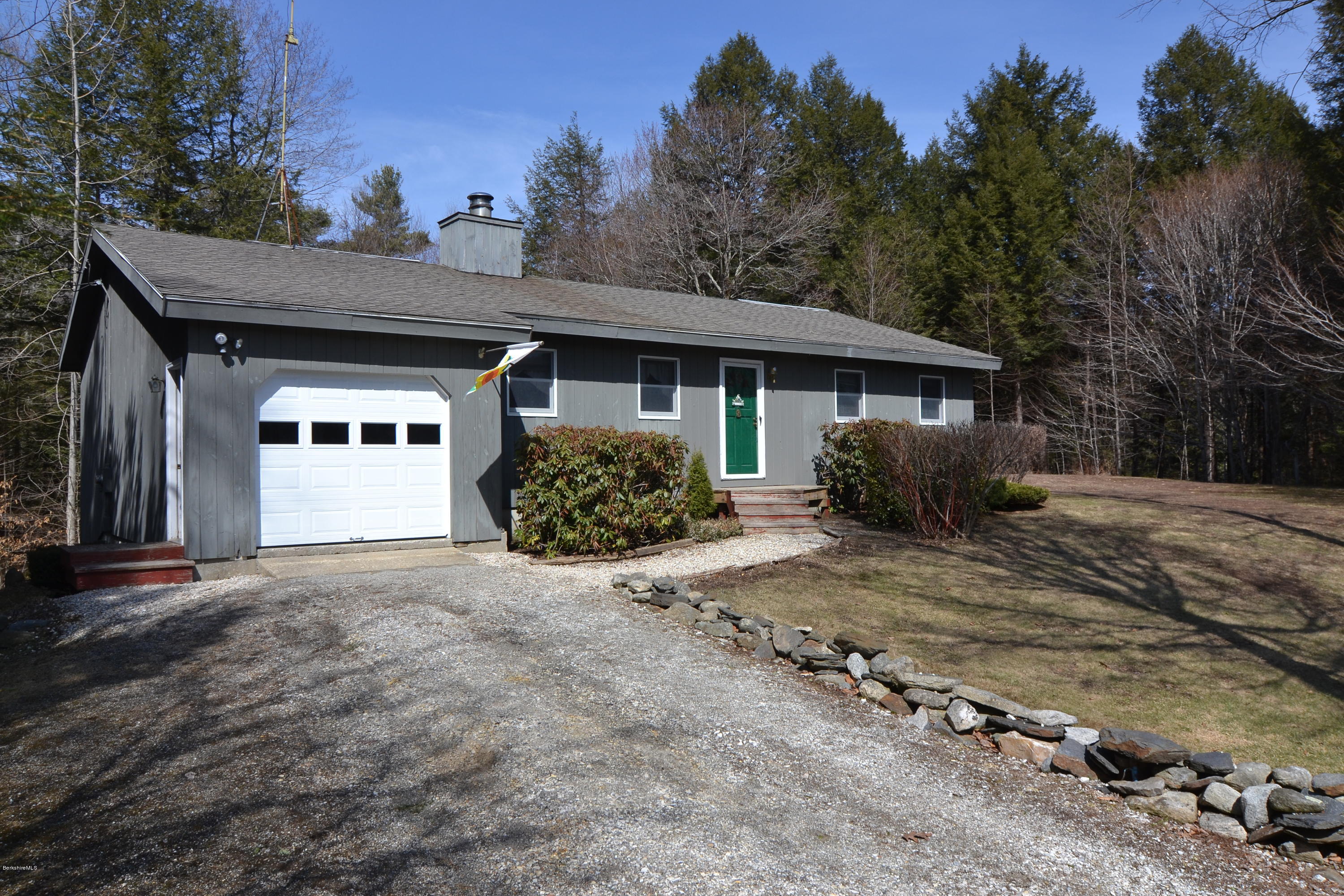 3008 Jacobs Ladder Road Becket, MA 01223 - Photo 1 of 28 a view of a house with a yard covered with snow and trees