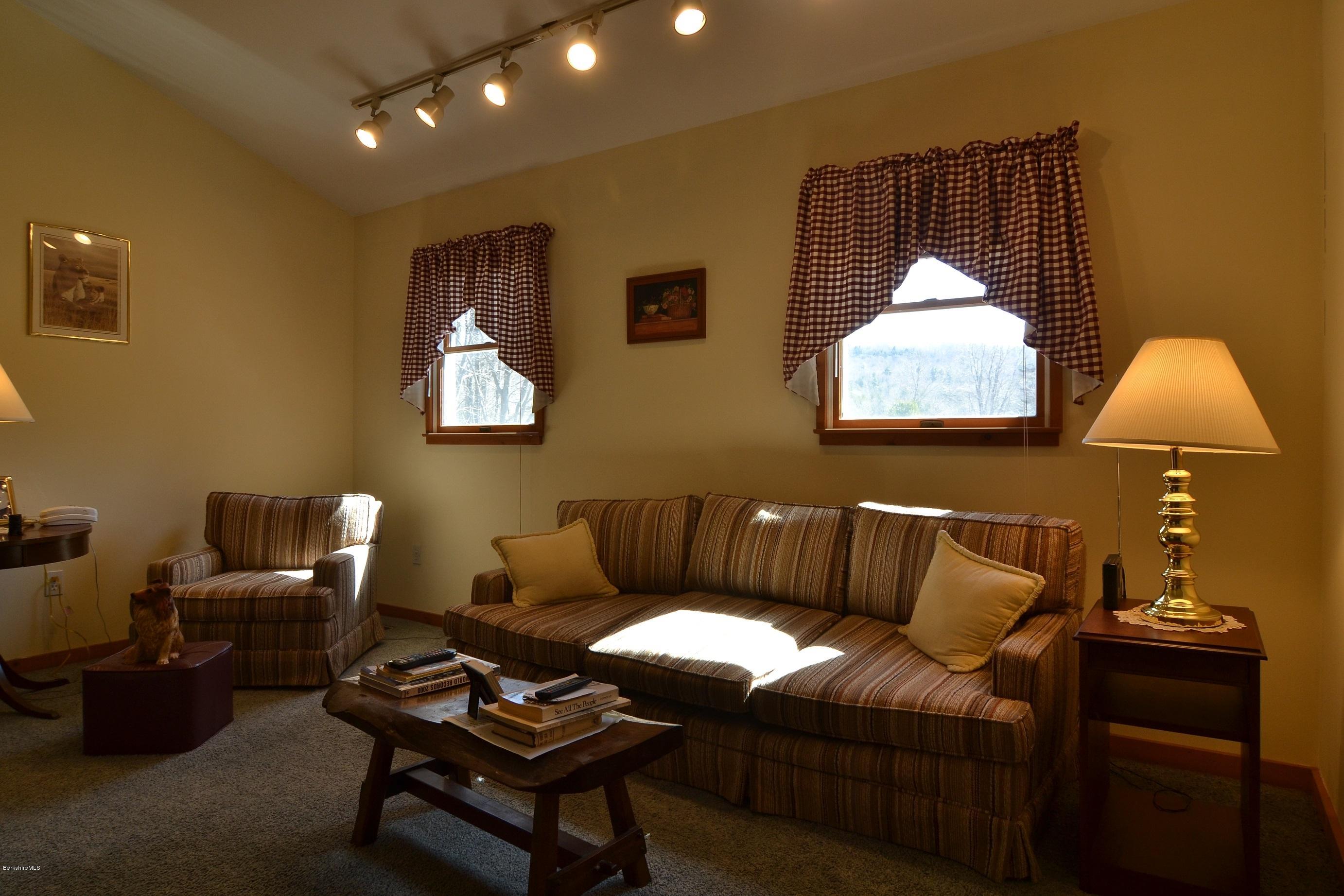 3008 Jacobs Ladder Road Becket, MA 01223 - Photo 11 of 28 a living room with furniture a lamp and a window