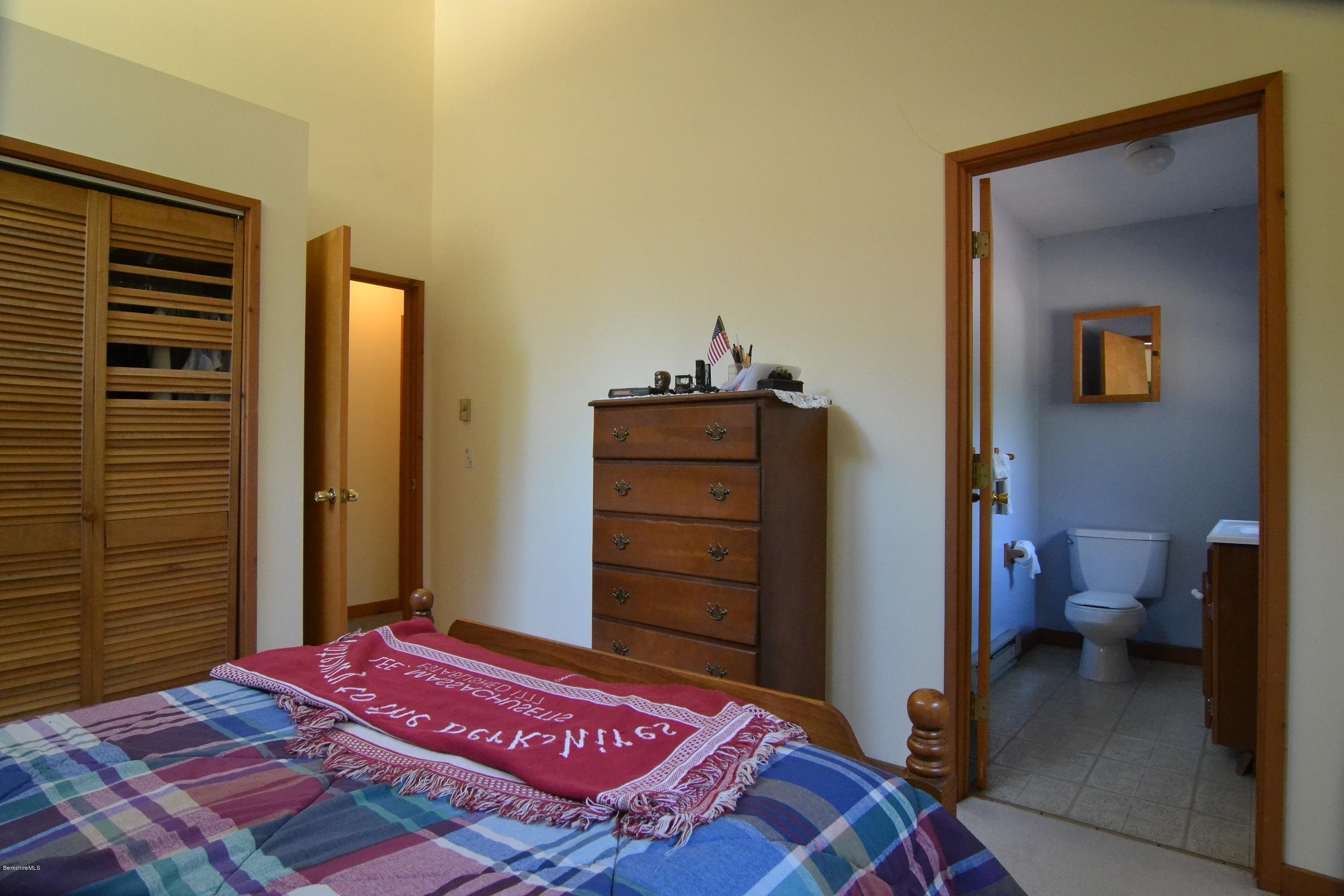 3008 Jacobs Ladder Road Becket, MA 01223 - Photo 17 of 28 a bedroom with a bed and a dresser
