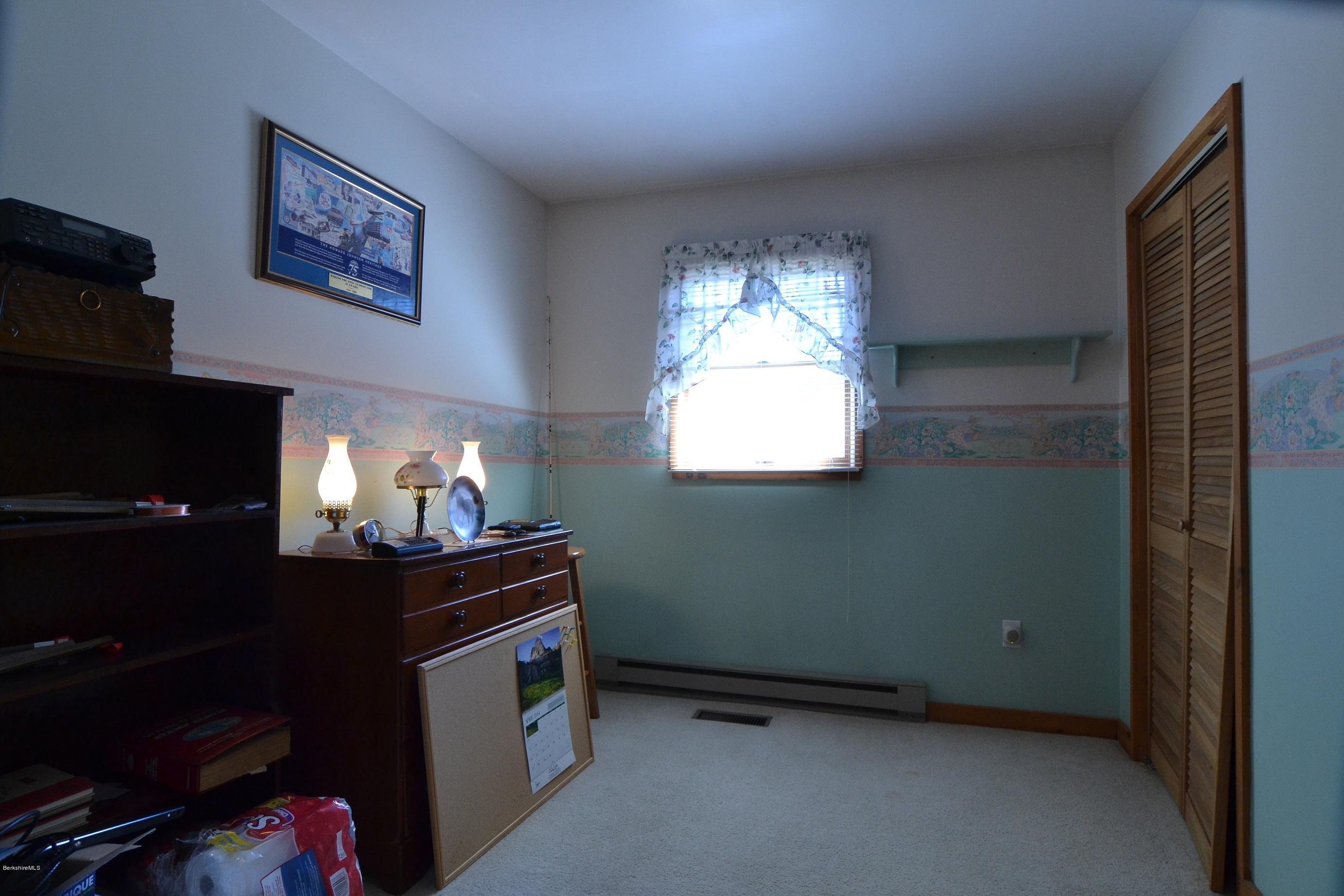 3008 Jacobs Ladder Road Becket, MA 01223 - Photo 21 of 28 a view of an empty room with a fireplace
