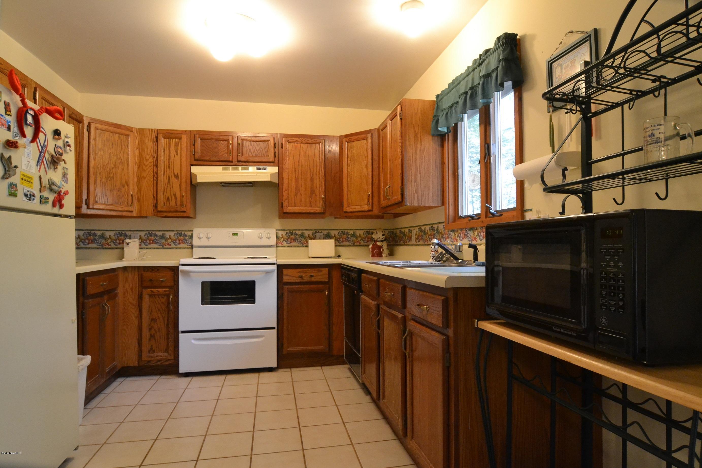 3008 Jacobs Ladder Road Becket, MA 01223 - Photo 4 of 28 a kitchen with a stove sink and cabinets