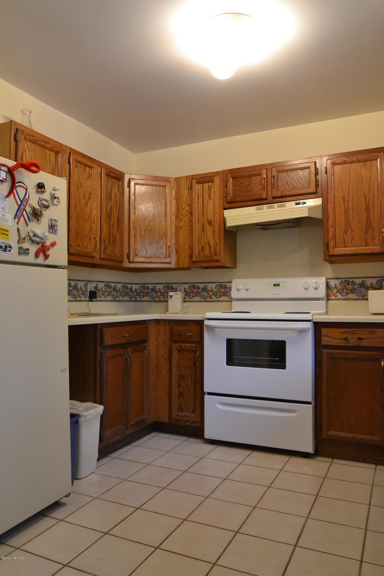 3008 Jacobs Ladder Road Becket, MA 01223 - Photo 5 of 28 a kitchen with stainless steel appliances granite countertop a stove a sink and a microwave