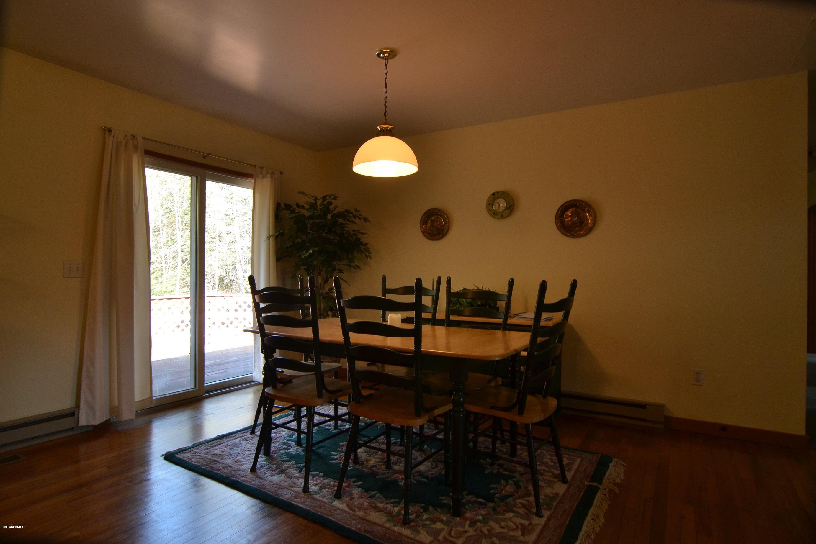 3008 Jacobs Ladder Road Becket, MA 01223 - Photo 9 of 28 a view of a dining room with furniture window and wooden floor