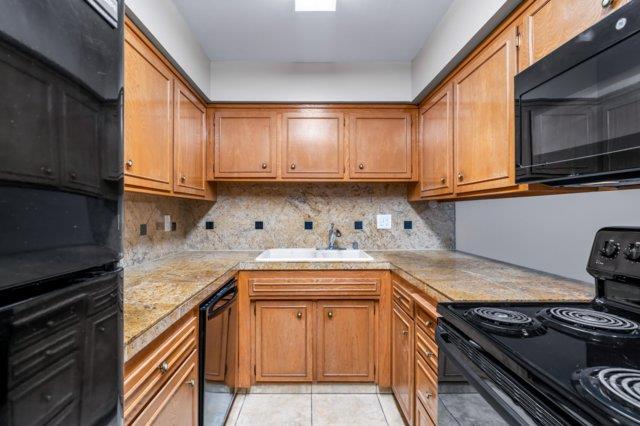 617 West Granger Avenue Modesto, CA 95350 - Photo 5 of 23 a kitchen with a stove sink and cabinets