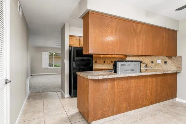 a kitchen with stainless steel appliances a sink and a refrigerator