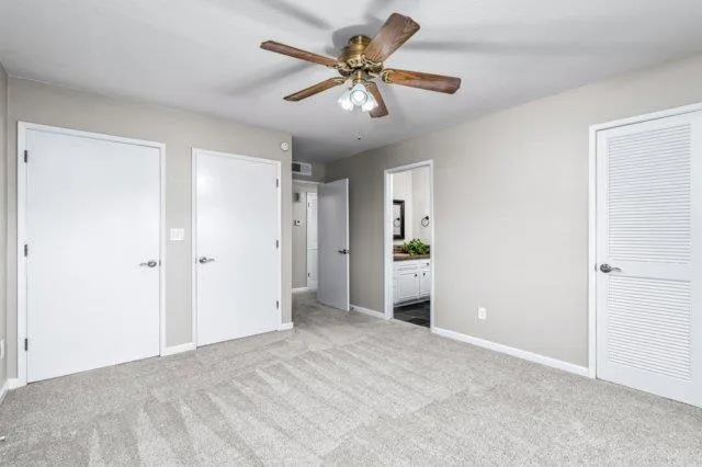a view of an empty room with a ceiling fan