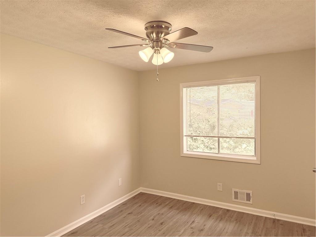 4707 Riverwood Circle Decatur, GA 30035 - Photo 12 of 17 a view of an empty room with wooden floor and a window