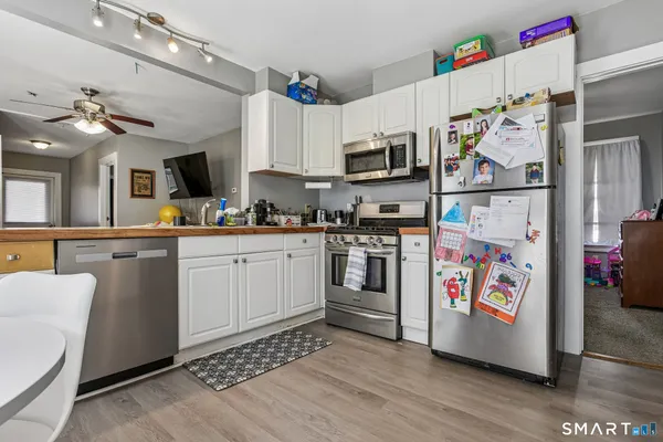 a kitchen with stainless steel appliances and white cabinets
