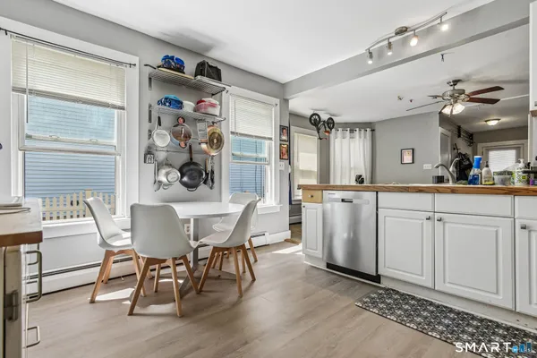 a kitchen with stainless steel appliances granite countertop a white cabinets and a stove