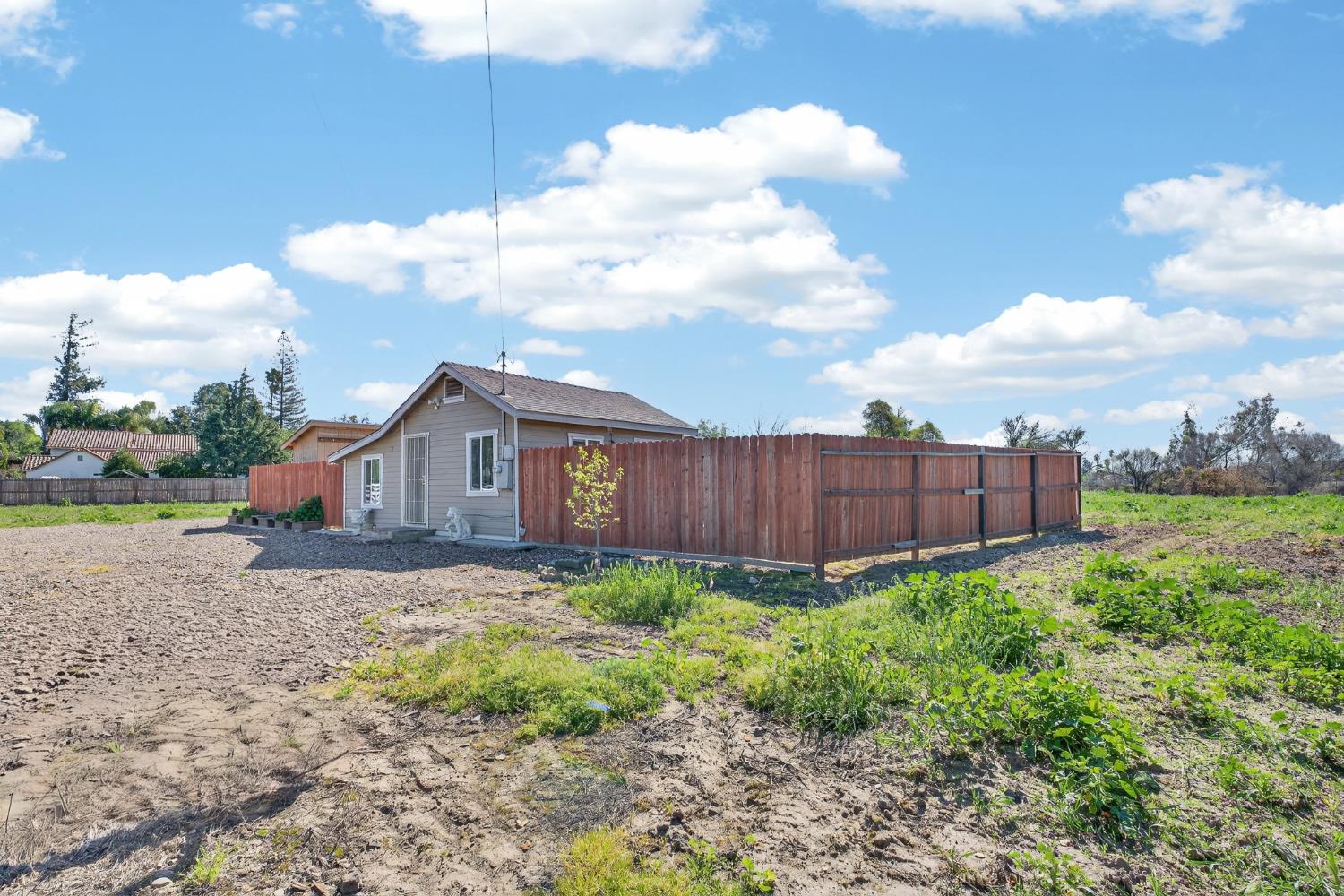 2504 Paradise Road Modesto, CA 95358 - Photo 2 of 14 a view of a house with a yard and fence