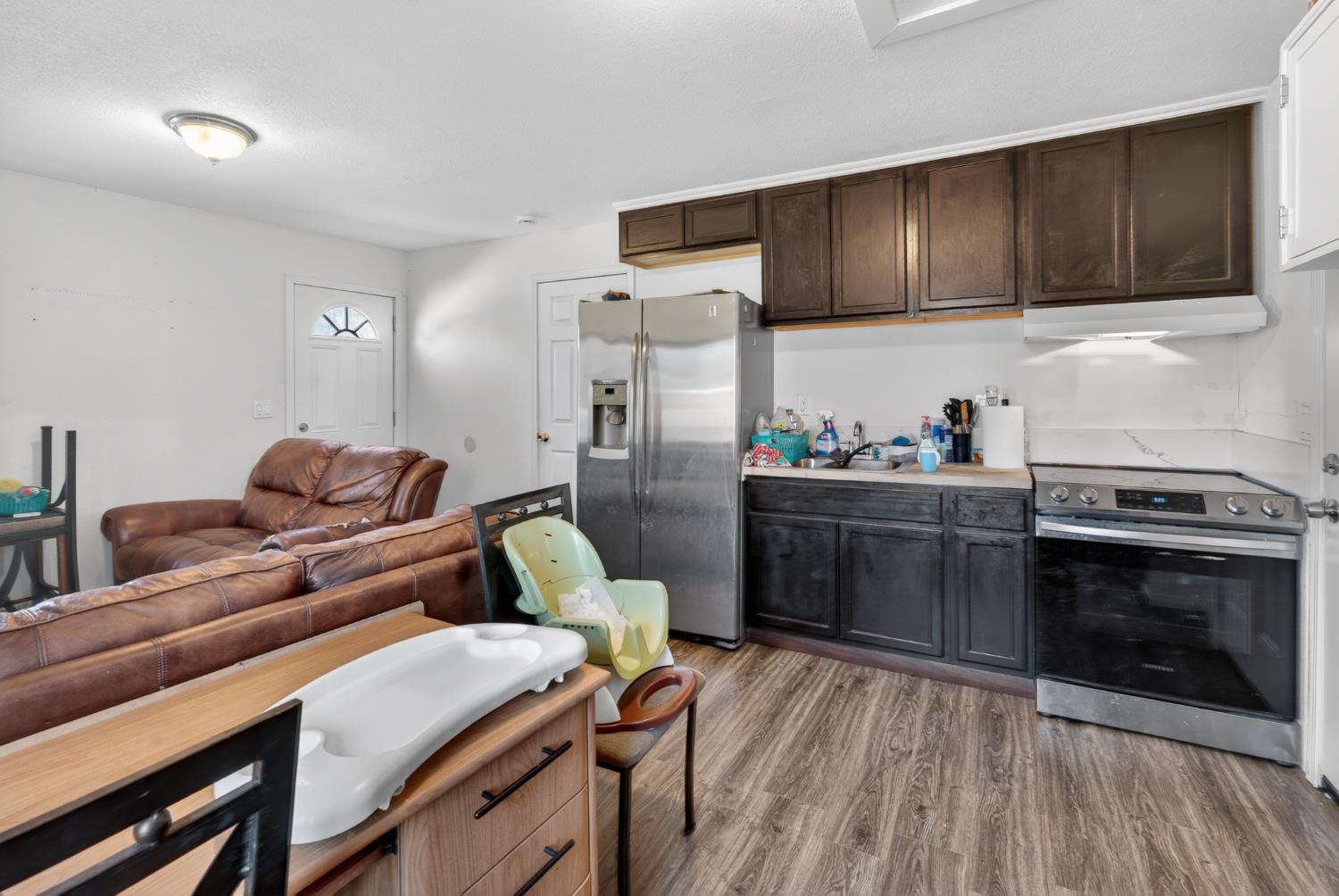 2504 Paradise Road Modesto, CA 95358 - Photo 3 of 14 a kitchen with stainless steel appliances wooden cabinets and a stove top oven