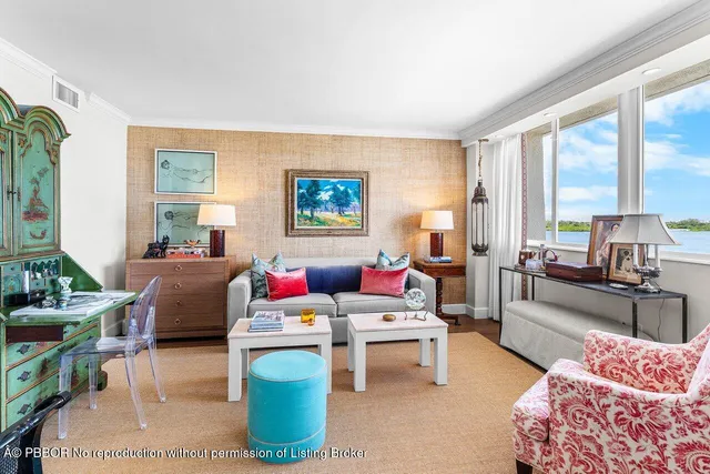 an empty room with large windows and an entrance