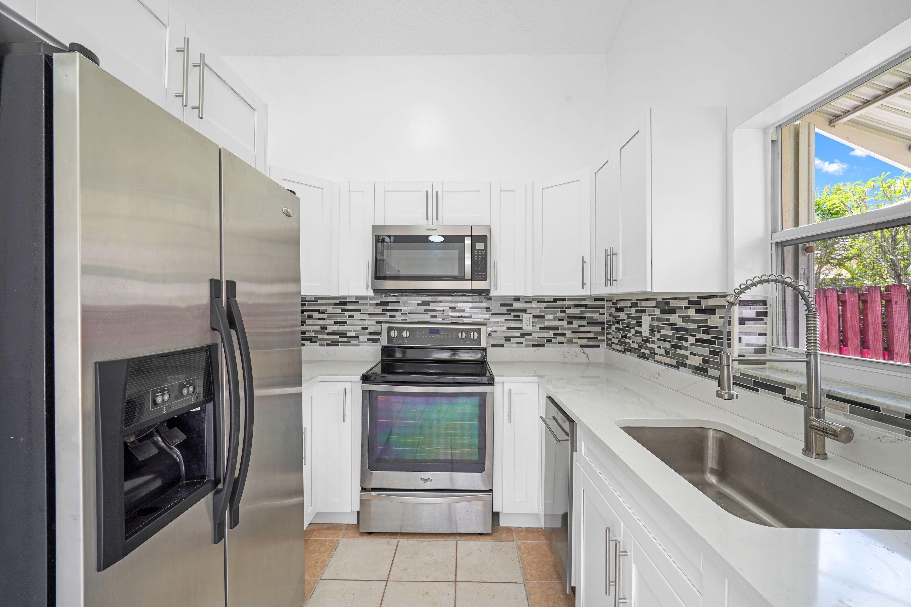 14142 Southwest 149th Court Miami, FL 33196 - Photo 12 of 48 a kitchen with a sink stove and oven