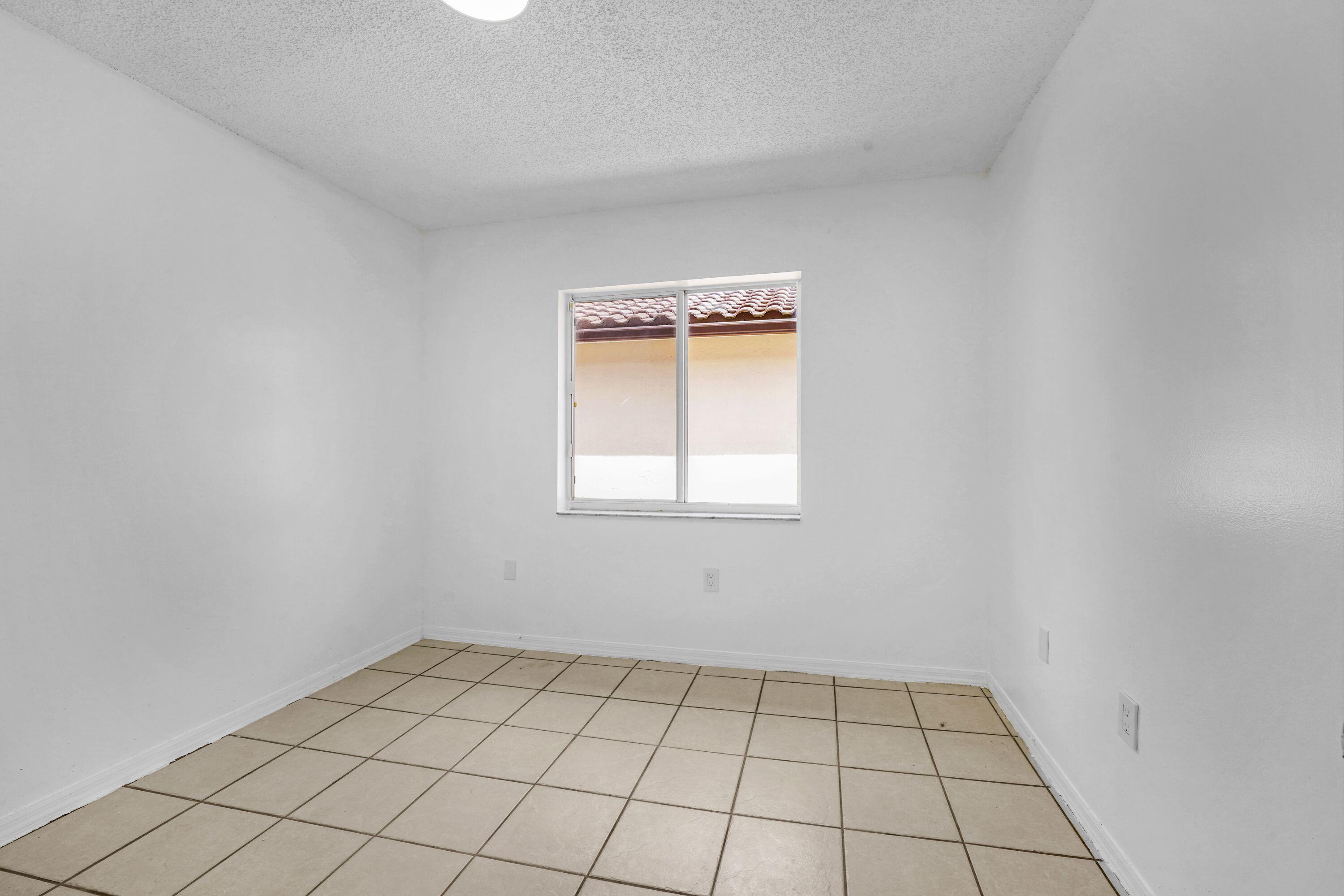 14142 Southwest 149th Court Miami, FL 33196 - Photo 16 of 48 an empty room with a window