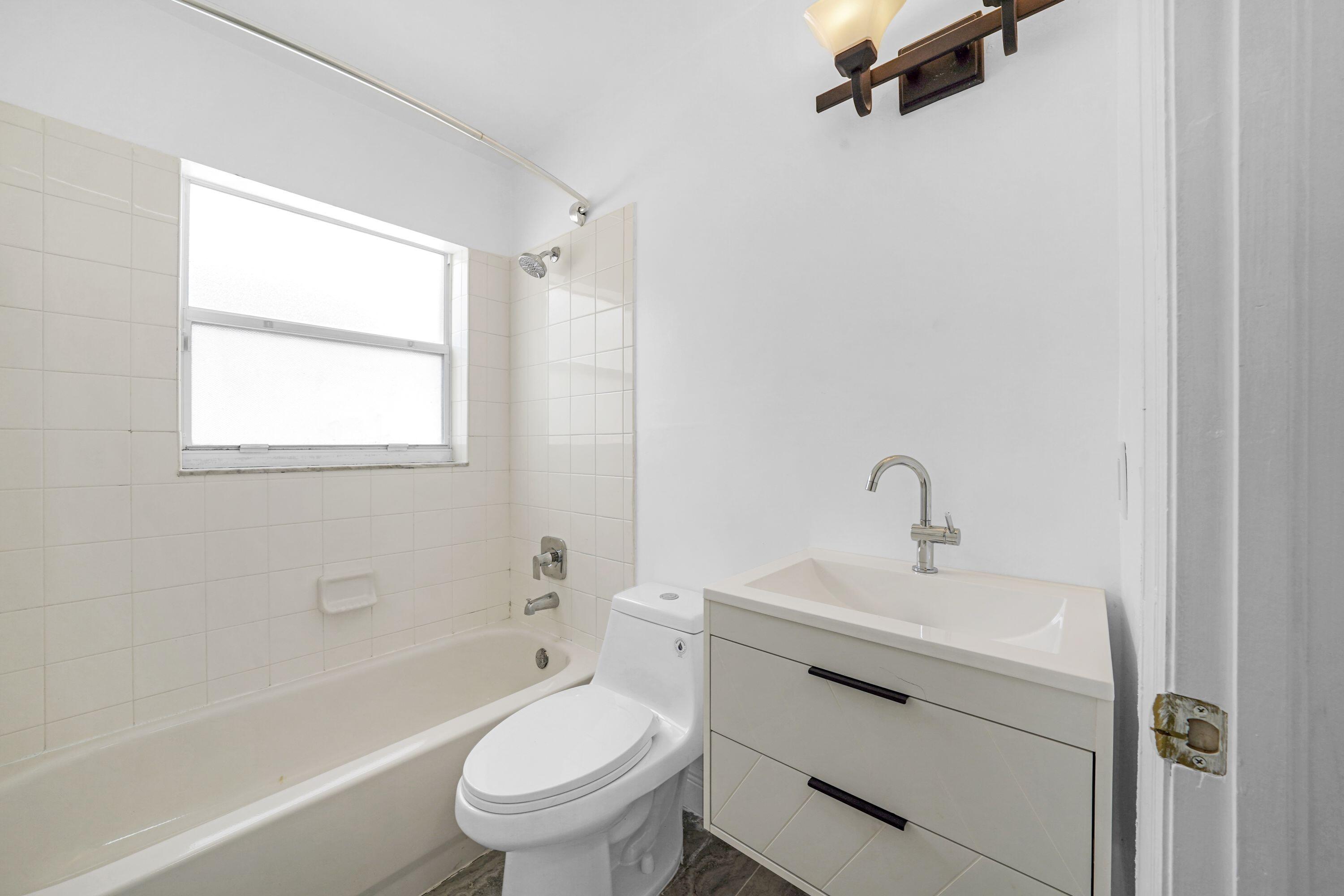 14142 Southwest 149th Court Miami, FL 33196 - Photo 17 of 48 a bathroom with a sink toilet vanity and bathtub