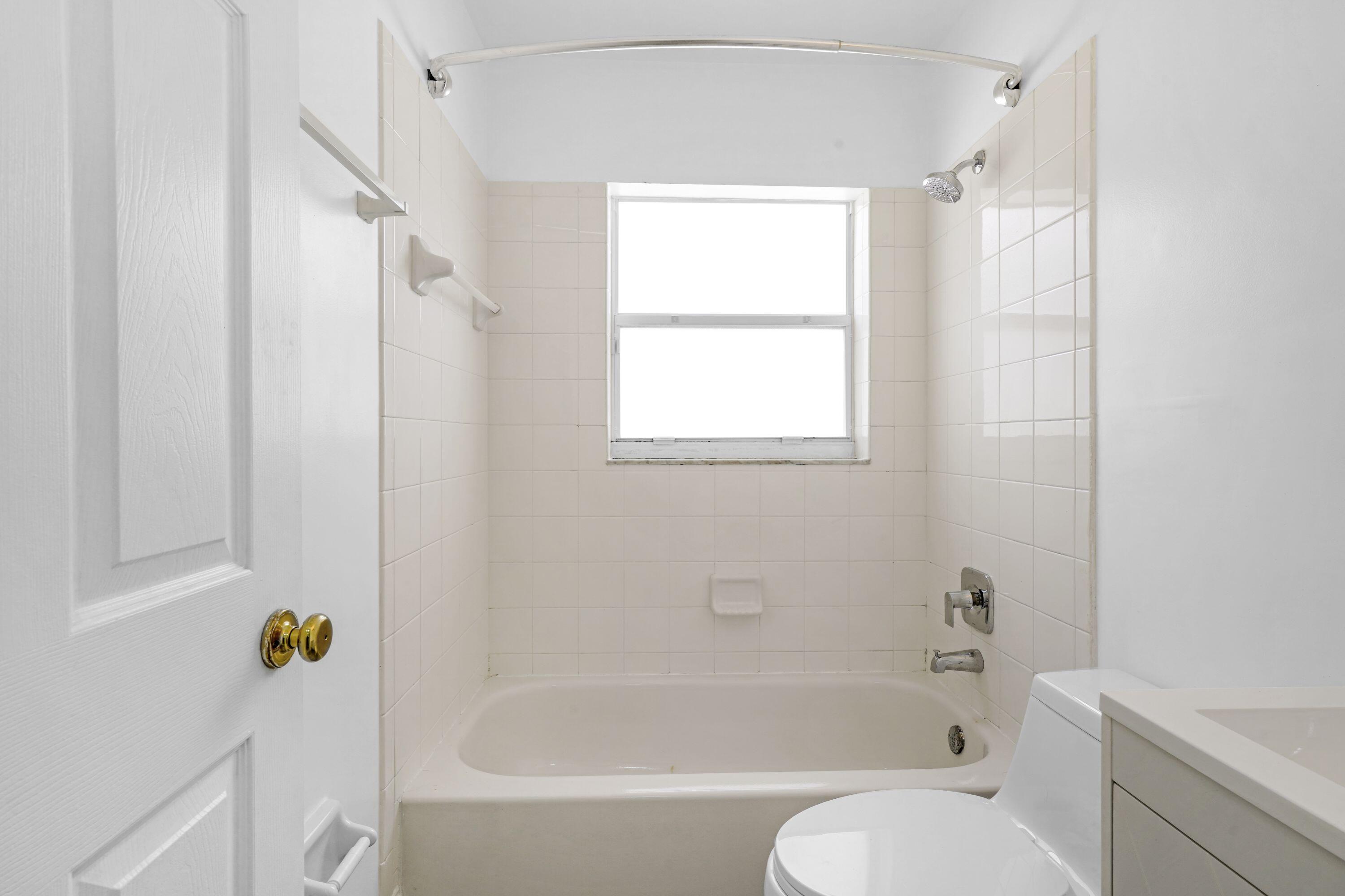 14142 Southwest 149th Court Miami, FL 33196 - Photo 18 of 48 a bath room with a toilet and a bath tub
