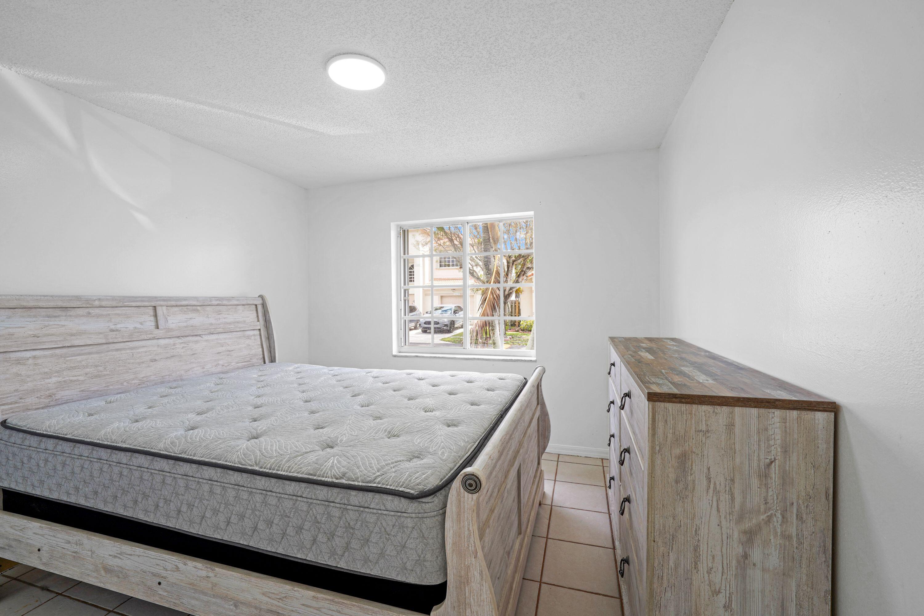 14142 Southwest 149th Court Miami, FL 33196 - Photo 19 of 48 a bedroom with a bed and window