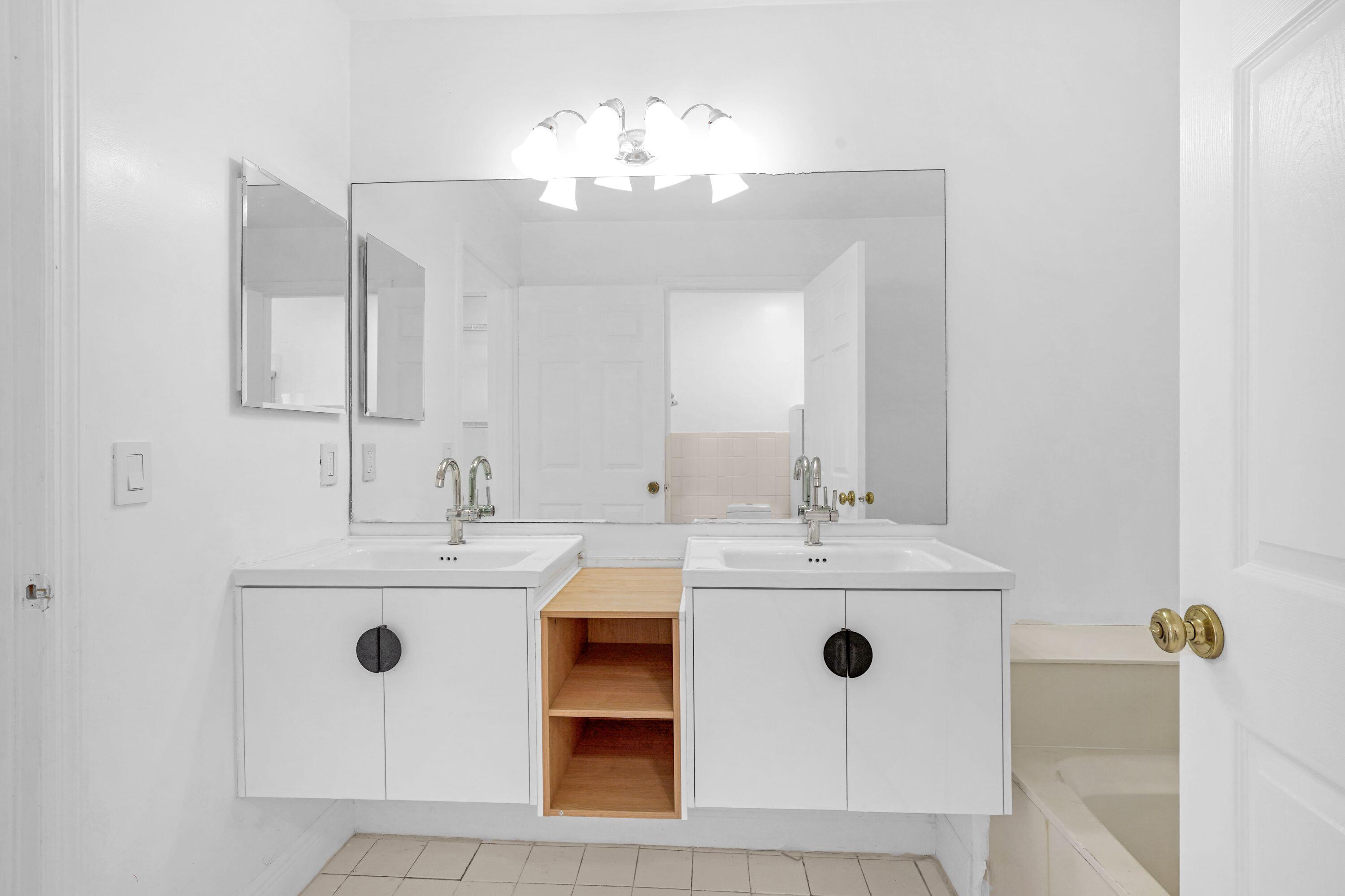 14142 Southwest 149th Court Miami, FL 33196 - Photo 26 of 48 a bathroom with a sink a mirror and vanity