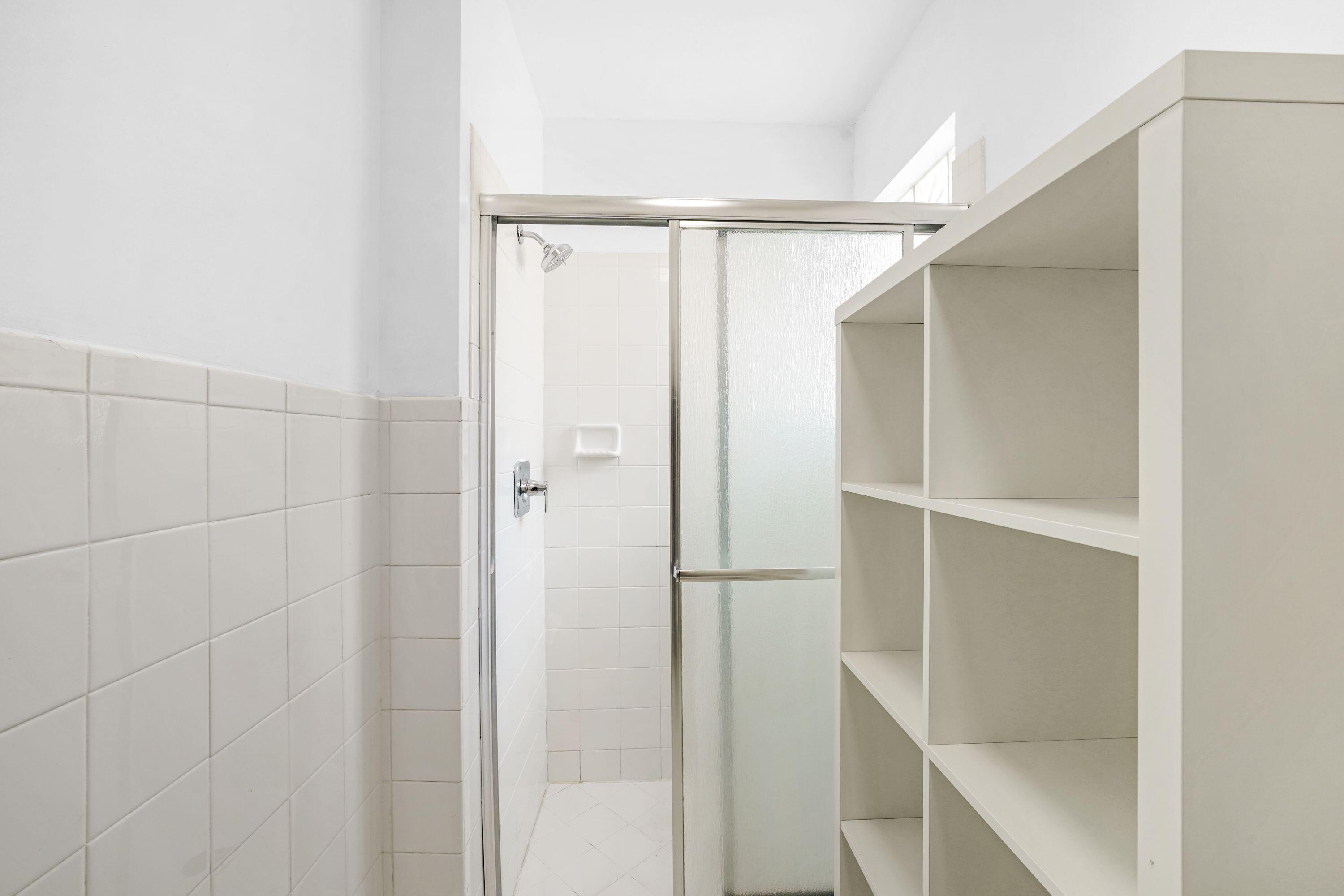 14142 Southwest 149th Court Miami, FL 33196 - Photo 28 of 48 a bathroom with a glass shower door
