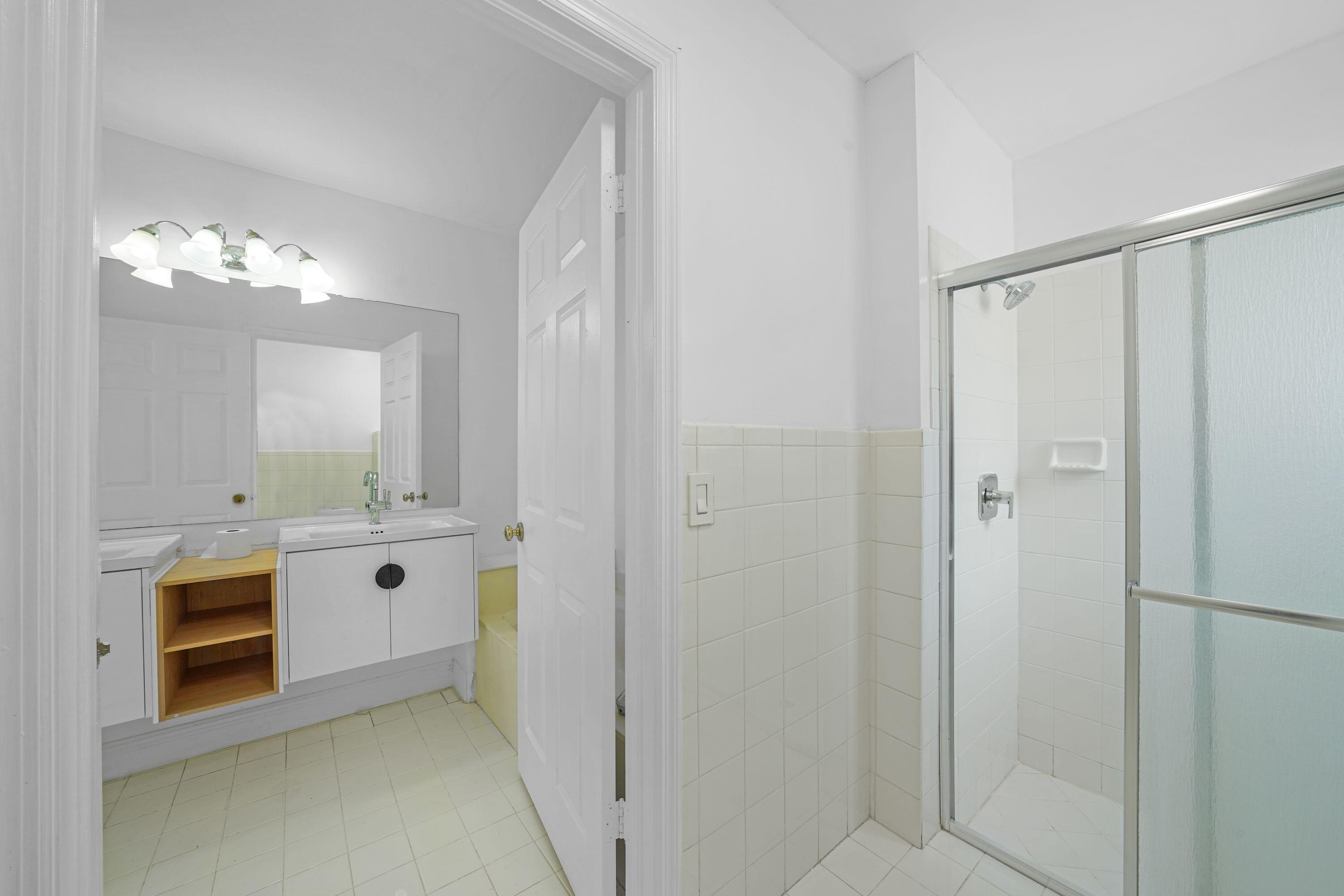 14142 Southwest 149th Court Miami, FL 33196 - Photo 29 of 48 a bathroom with a double vanity sink and mirror