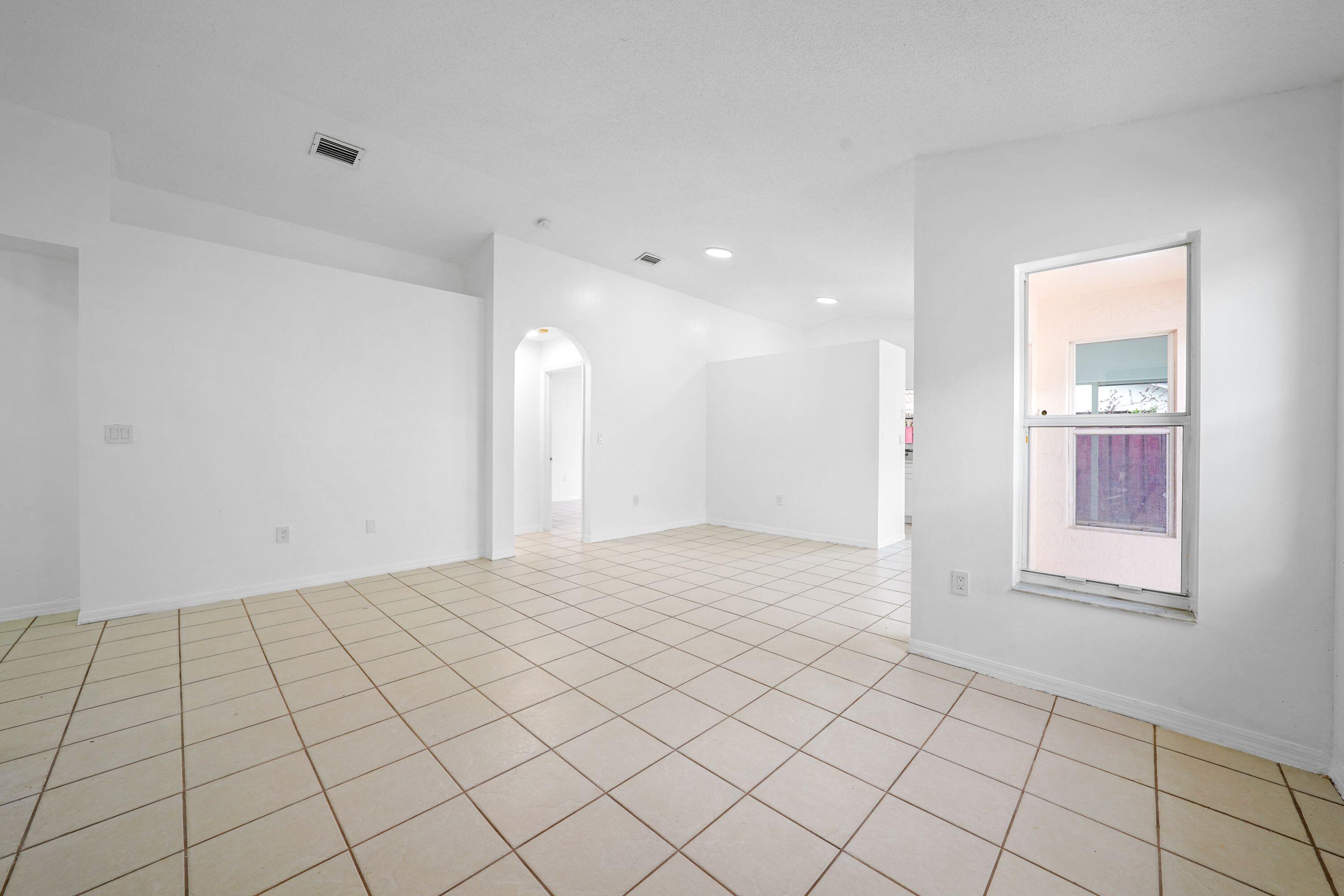 14142 Southwest 149th Court Miami, FL 33196 - Photo 3 of 48 a view of an empty room and window
