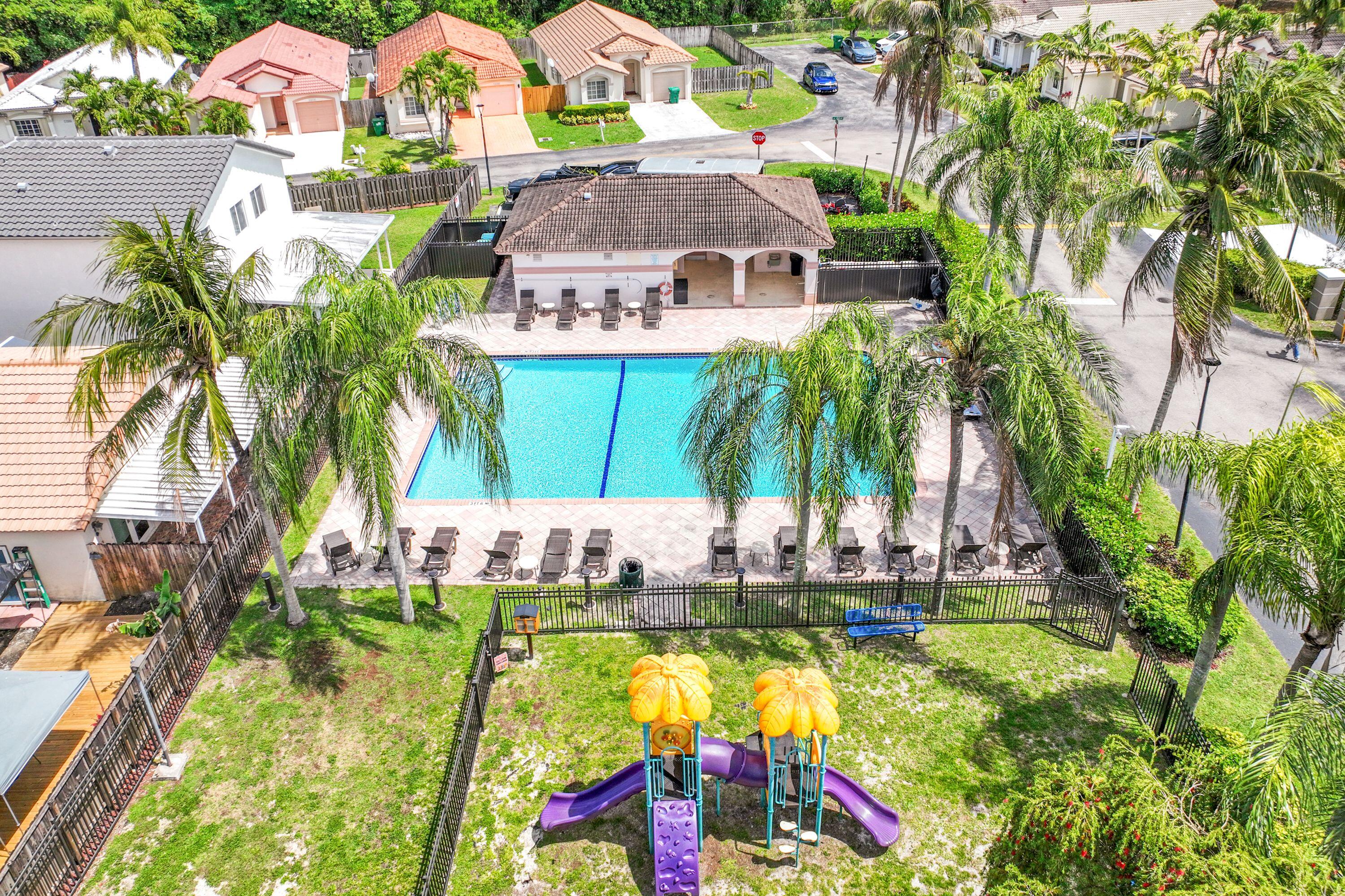 14142 Southwest 149th Court Miami, FL 33196 - Photo 44 of 48 a view of swimming pool with a garden and palm trees