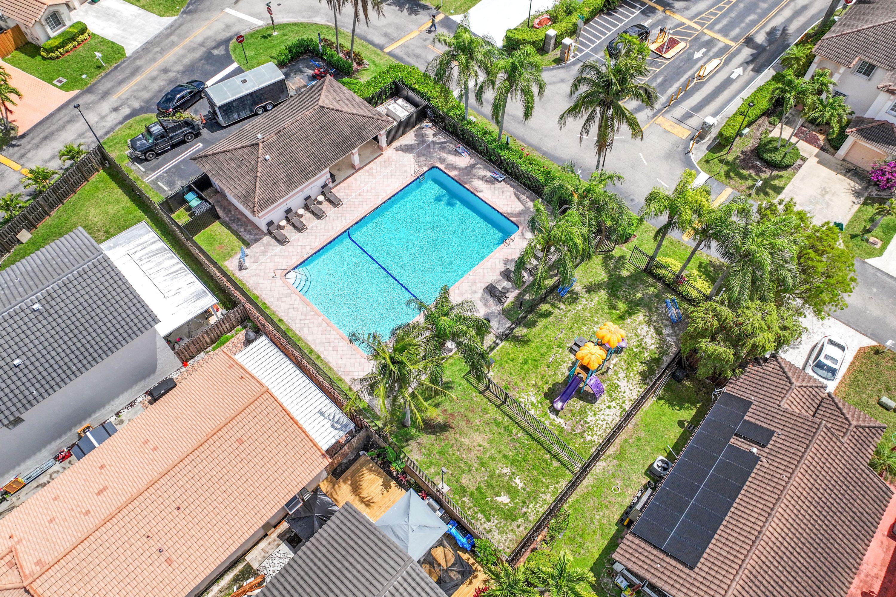 14142 Southwest 149th Court Miami, FL 33196 - Photo 45 of 48 an aerial view of a tennis ground with a large pool