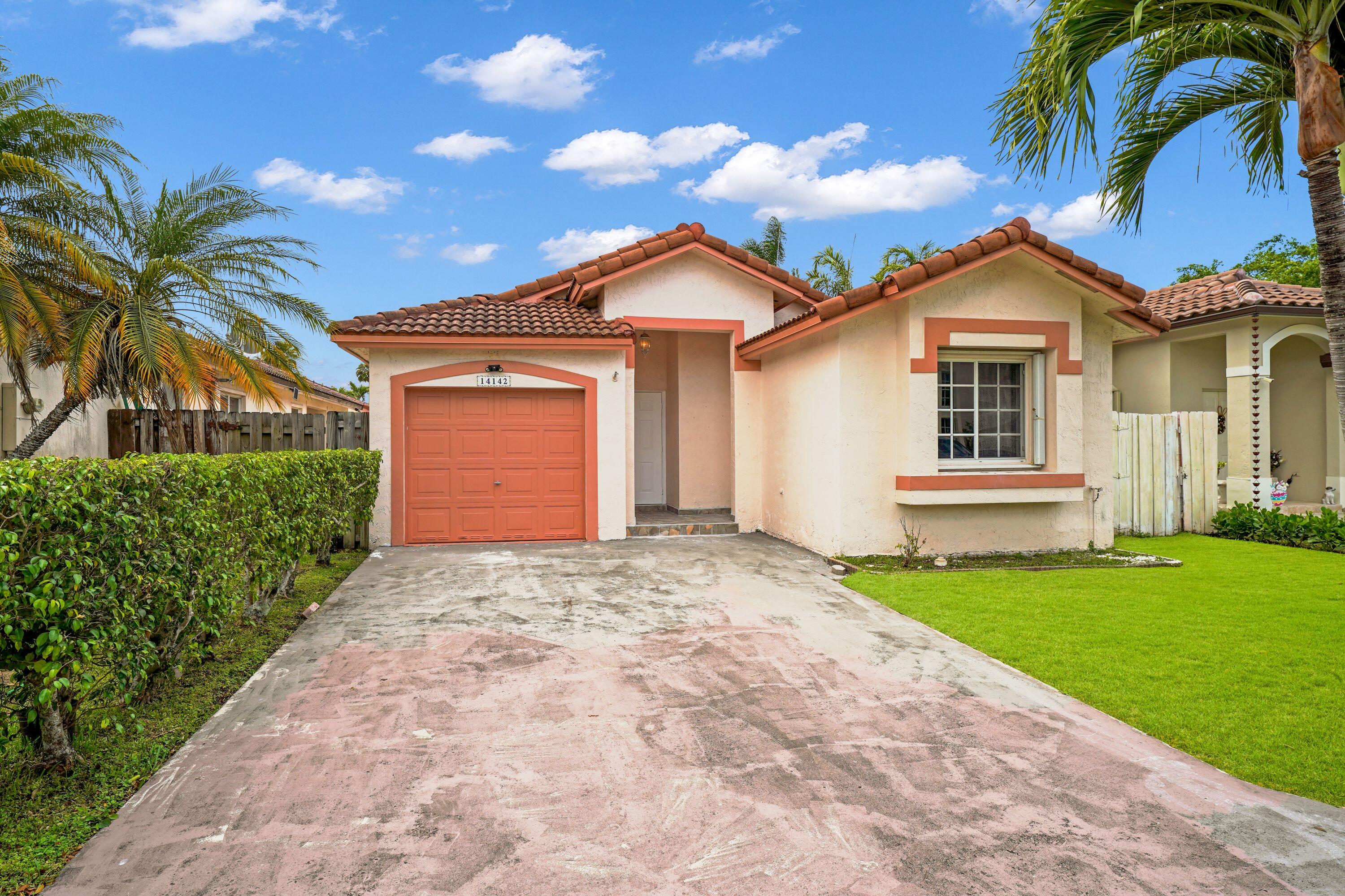 14142 Southwest 149th Court Miami, FL 33196 - Photo 46 of 48 a front view of a house with a yard and garage