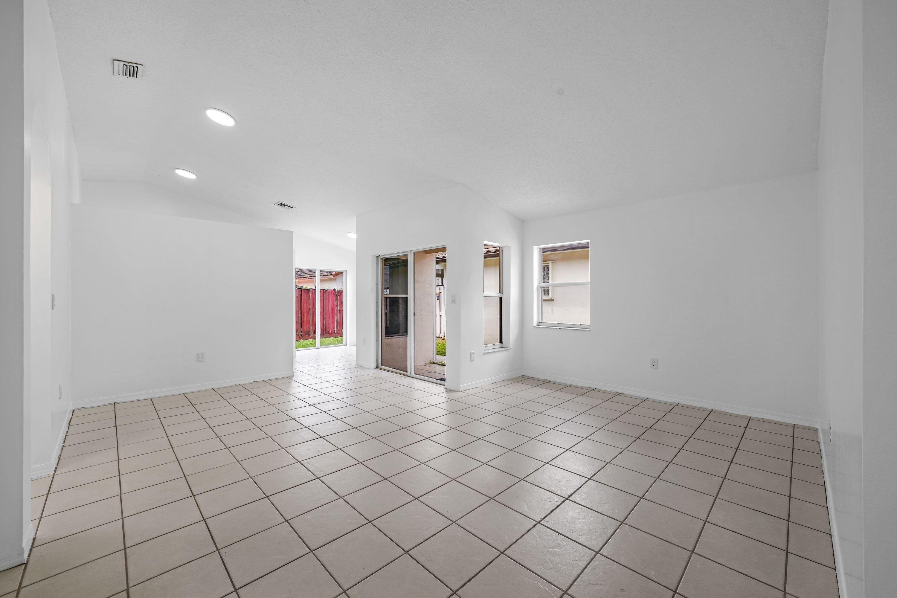 14142 Southwest 149th Court Miami, FL 33196 - Photo 5 of 48 a view of an empty room and window