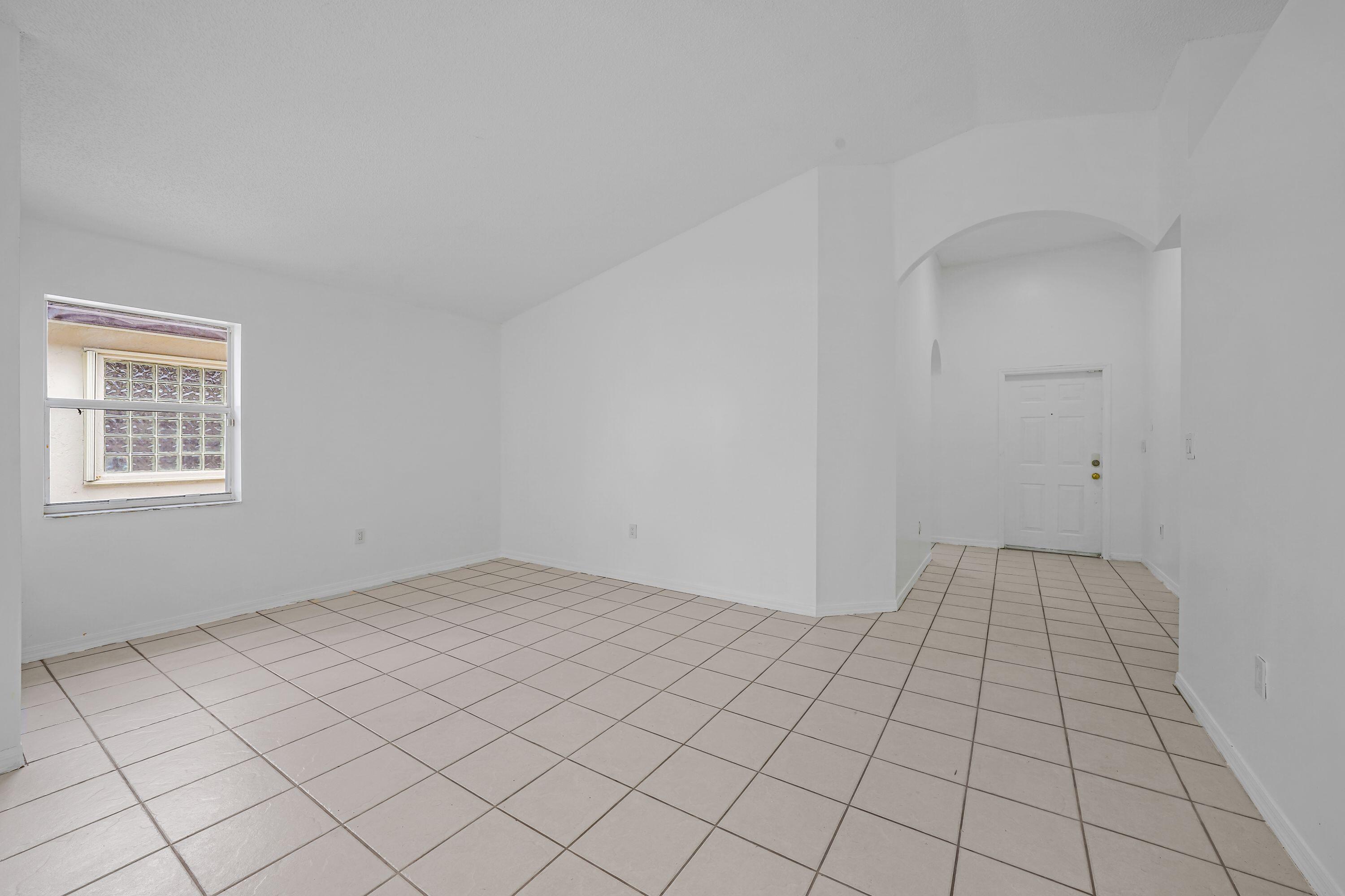 14142 Southwest 149th Court Miami, FL 33196 - Photo 7 of 48 a view of an empty room and window
