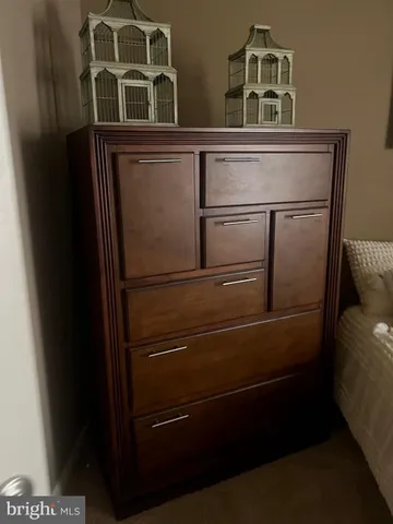 a close view of a refrigerator in kitchen and an empty room