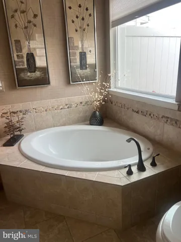 a bath tub sitting in a bathroom next to a sink
