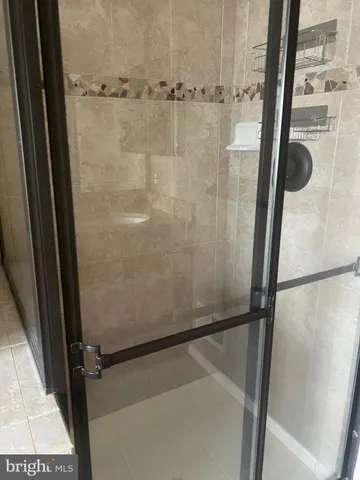 a bathroom with a glass shower door