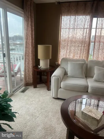 a living room with furniture and a floor to ceiling window