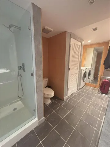 a bathroom with a toilet and a shower