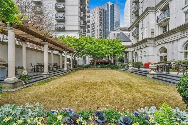 a swimming pool with outdoor seating and yard