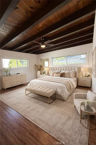 a bedroom with bed couch and window