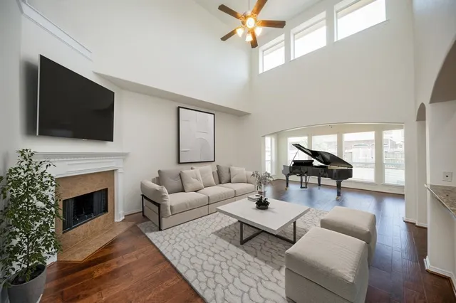 a living room with furniture a fireplace and a flat screen tv