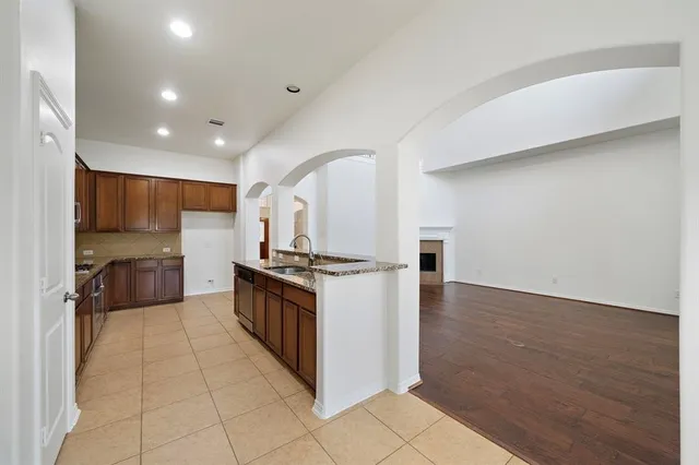 a kitchen with stainless steel appliances granite countertop a stove and a sink