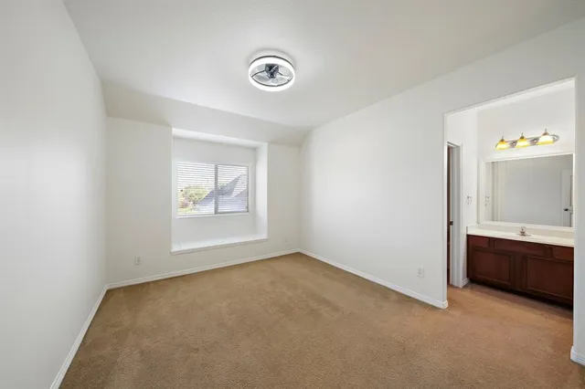 a bathroom with a tub sink toilet and mirror