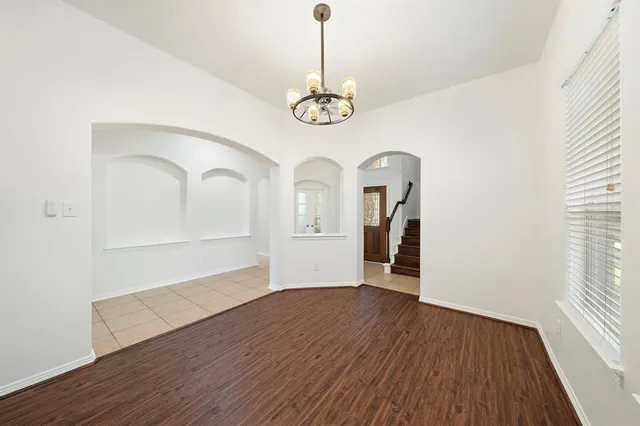a view of a room with wooden floor closet and windows