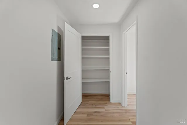 a view of walk in closet with empty racks