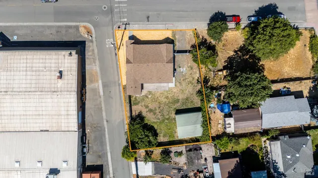 an aerial view of a house with a yard